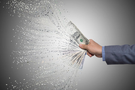 Businessman holding USD banknotes which its decompose for Dollar inflation and priceless concept.の写真素材