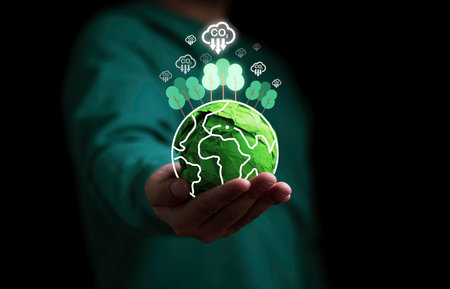 Businessman holding green scrap paper ball with virtual world  trees and carbon reduction icon for absorb carbon dioxide to carbon credit ,limit global warming from climate change concept.の写真素材