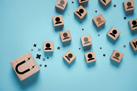 Magnet icon magnetize to human icon which print screen on wooden block cube for catch customer...