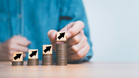 Business putting up arrow on the top of increasing coins stacking with copy space for Salary Increase, Insurance Cost up And Capital Rise concept.の写真素材