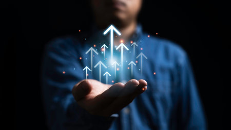Businessman holding up arrow for business growth strategy on success development until achievement target and profit concept.の写真素材