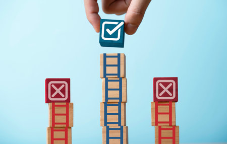 Hand stacking correct sign symbol mark on the op of ladder and among of cross sign for project and document approve project concept.の写真素材