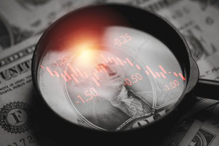 Red down arrow inside of magnifier glass and USD dollar banknote for United States of America or USA economic recession concept.の写真素材