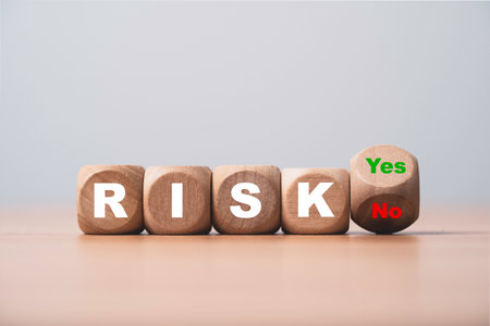 Flipping of yes no with risk wording on wooden block cube for risk management and assessment concept.の写真素材