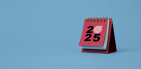 2025 with white dartboard arrow on red calendar for setup business setup objective  target and goal when change to new year concept.の写真素材