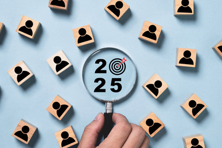 2025 and dartboard arrow inside of magnifier glass with human icon for setup business setup objective  target and goal when change to new year concept.の写真素材