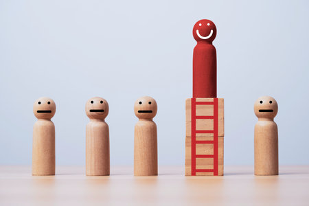 Red figure smile and standing on the top of red ladder among regular figure for promotion and human development concept.の写真素材
