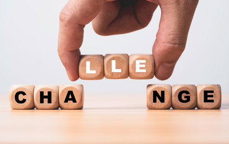 Hand holding alphabet to alternate wording from change and challenge concept.の写真素材
