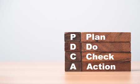 PDCA and Plan Do check Action print screen on wooden block cube for Continuous Quality improvement or KAIZEN concept.の写真素材