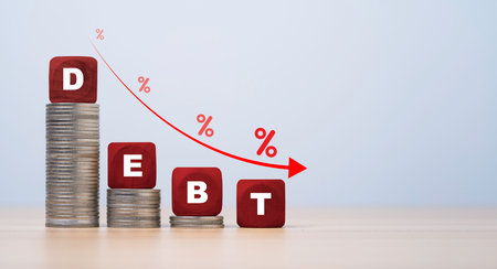 Debt wording on the top of decreasing coins stacking with down arrow and percentage for debt reducing concept.の写真素材