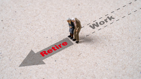 Miniature figure couple Senior Pensioners standing with work and retirement wording.の写真素材