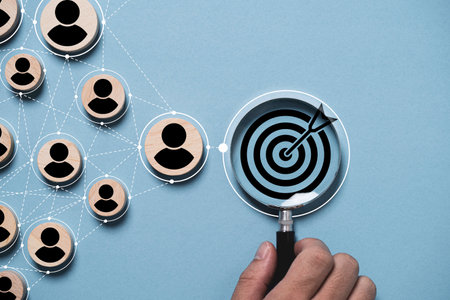 Dartboard and black arrow inside magnifier glass with connection linkage between human icon for customer focus target group and customer relation management concept.の写真素材