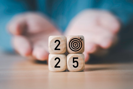 Businessman giving 2025 with dartboard arrow print screen on wooden block cube for setup business setup objective  target and goal when change to new year concept.の写真素材