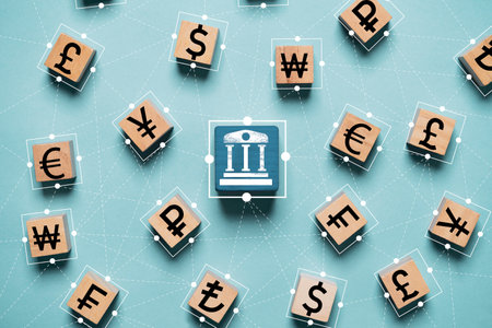 Central banking print screen on wooden block and linkage with international currency include dollar Yuan Yen Pound sterling and Euro for forex currency exchange money transfer concept.の写真素材