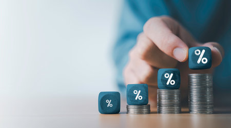 Businessman putting percentage sign on increasing coins money for financial banking increase interest rate or mortgage investment dividend from business growth concept.の写真素材