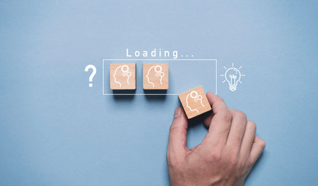 Hand assemble human thinking icon to loading bar from question mark to glowing lightbulb for...