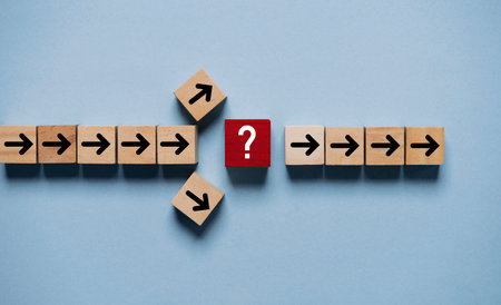 Question mark print screen on red wooden block cross in the middle of arrow for interrupt of process concept.の写真素材