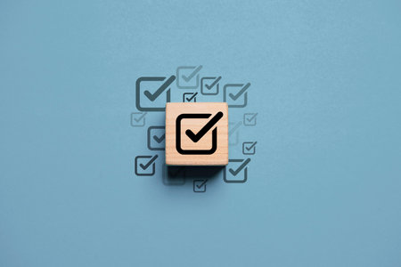 Black correct sign mark on wooden block cube for project and document approval concept.の写真素材