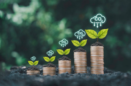Plant growing on coins stacking with carbon reduction sign for carbon credit and footprint can make more business profit and  limit global warming from climate change concept.の写真素材