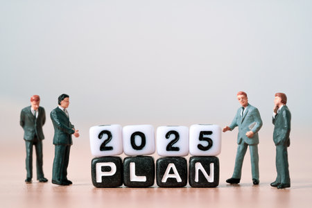 Businessmen miniature figure standing with 2025 plan for business strategy planning in new year concept.の写真素材