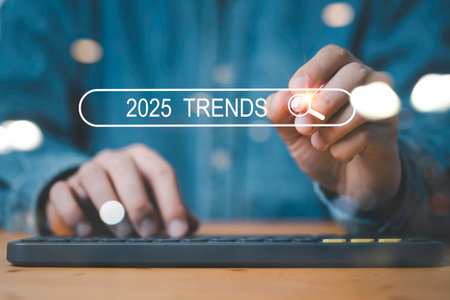 Businessman using computer keyboard and touching to search bar with 2025 trends for business and fashion in new year concepの写真素材