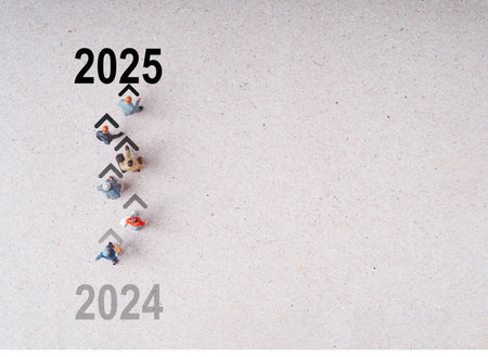 Top view of Miniature figures walking from 2024 to 2025 with copy space for preparation of happy new year coの写真素材