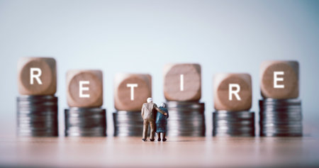 Miniature figure of Couple Senior Pensioners standing between coins stacking  for wealth financial planning ,money saving and life insurance of retirement concept.の写真素材
