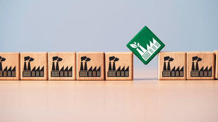 Green factory concept shown among industrial buildings, illustrating transition towards reduced carbon dioxide emissions and environmental sustainability.の写真素材