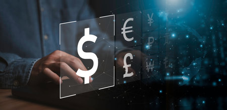 Businessman using computer laptop with international currency sign include dollar pound sterling...