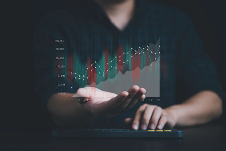 Businessman holding virtual bar graph chart and percentage for analysis stock market, technology investment and value investment concept.の写真素材