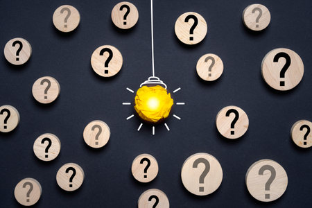Yellow scrap paper which it sign of lightbulb glowing among questions mark for creative thinking...