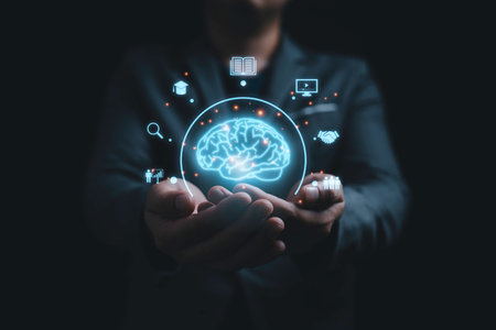 Businessman holding virtual glowing Brain with knowledge icons for study concept.の写真素材