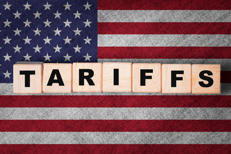 Tariffs wording on USA flag for united stats of America announced tax barrier of imports goods from every countries of trade war concept.の写真素材
