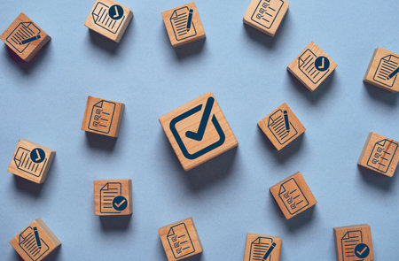 Correct tick sign mark on wooden block cube among document preparation check and approve for ISO and quality audit concept.の写真素材