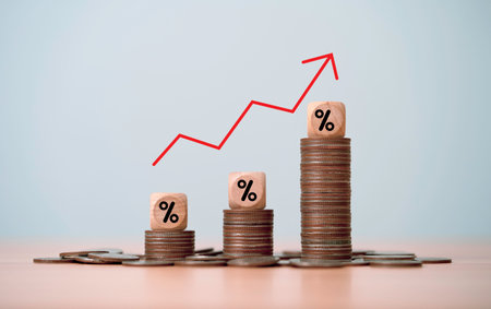 Increasing coins stacking with percentage and up arrow for money saving to get interest and dividend concept.の写真素材