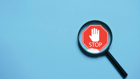 Red stop warning sign symbol inside of magnifier glass for focus  traffics regulation control concept.の写真素材
