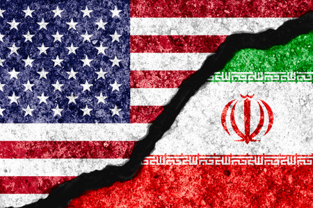 Concrete wall crack separate between USA flag and IRAN flag for conflict military war between United States of America and Iran concept.の写真素材