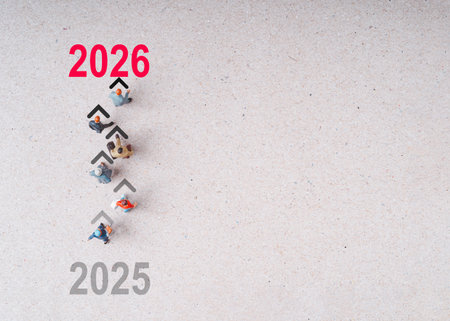 Many Miniature figures walking  including shopper businessmen businesswomen from 2025 to 2026 for start new business investment since new year concept.の写真素材