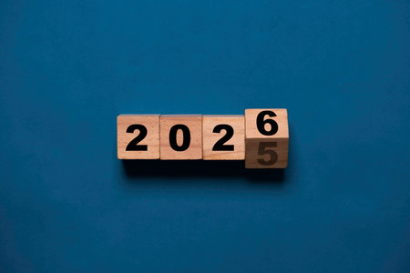 Flipping of 2025 to 2026 on wooden block cube for preparation new year change and start new business target strategy concept.の写真素材