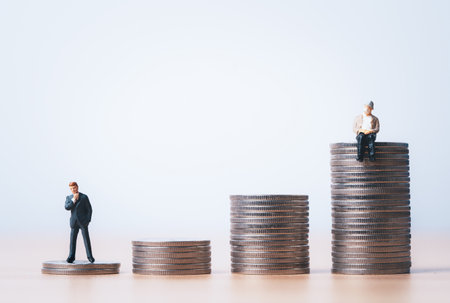 Miniature figure young businessman standing and Senior Pensioners sitting on the top coins stacking...
