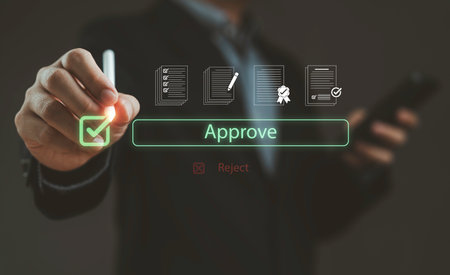 Businessman pressing digital approve button with check mark, symbolizing online agreement contract approval certification business decision document verification and successful authorization.の写真素材