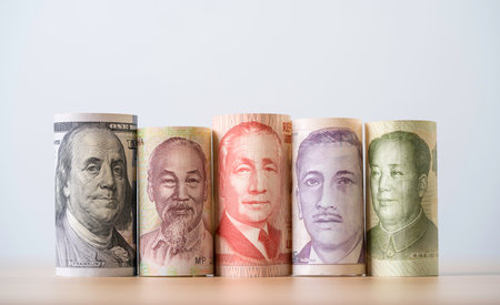 Rolled paper currencies from different countries representing currency exchange forex trade global finance investment and international economic market concept for business growth.の写真素材