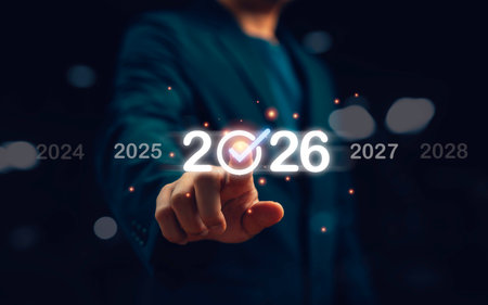 Businessman pointing at glowing 2026 with check mark symbol representing new year goal achievement planning success and futuristic vision for business growth innovation and technology progress.の写真素材