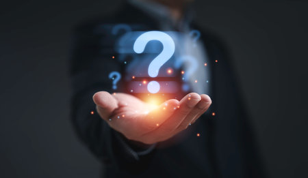 Businessman holding glowing question mark symbol representing problem solving uncertainty curiosity innovation decision making challenge and creative thinking concept in business and technology.の写真素材