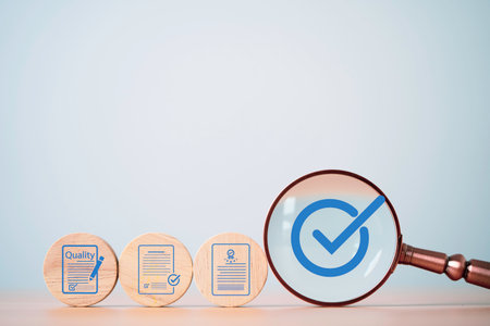 Magnifying glass focusing on blue check mark with wooden blocks showing approved documents and...