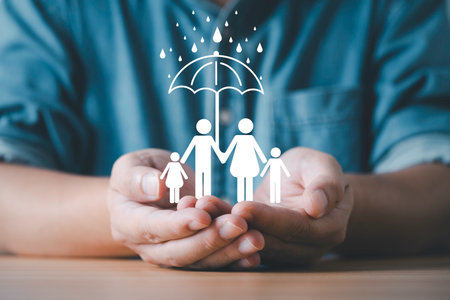 Businessman hands protecting a family under an umbrella symbol representing insurance safety...
