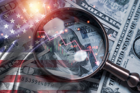 Magnifying glass over US dollar banknotes with declining financial chart and American flag represent economic recession of inflation crisis, stock market downturn and global financial risk conceptの写真素材