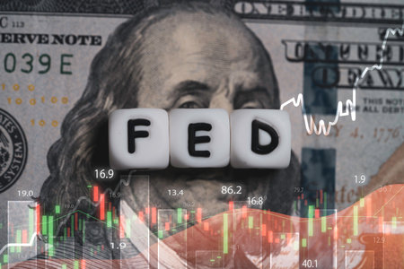 Double exposure of with stacked dice spelling FED on dollar bills , American flag and stock market...