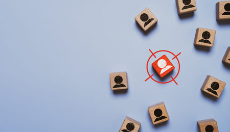 Target marketing strategy concept with connected wooden people icons and central goal symbol. Business networking, audience segmentation and leadership planning for growth and performance success.の写真素材