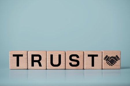 Trust business concept with trust on wooden blocks and handshake icon. Corporate integrity,...
